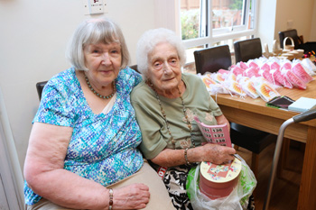 Resident Edna and friend selling raffle tickets at the Birch Green summer fayre.